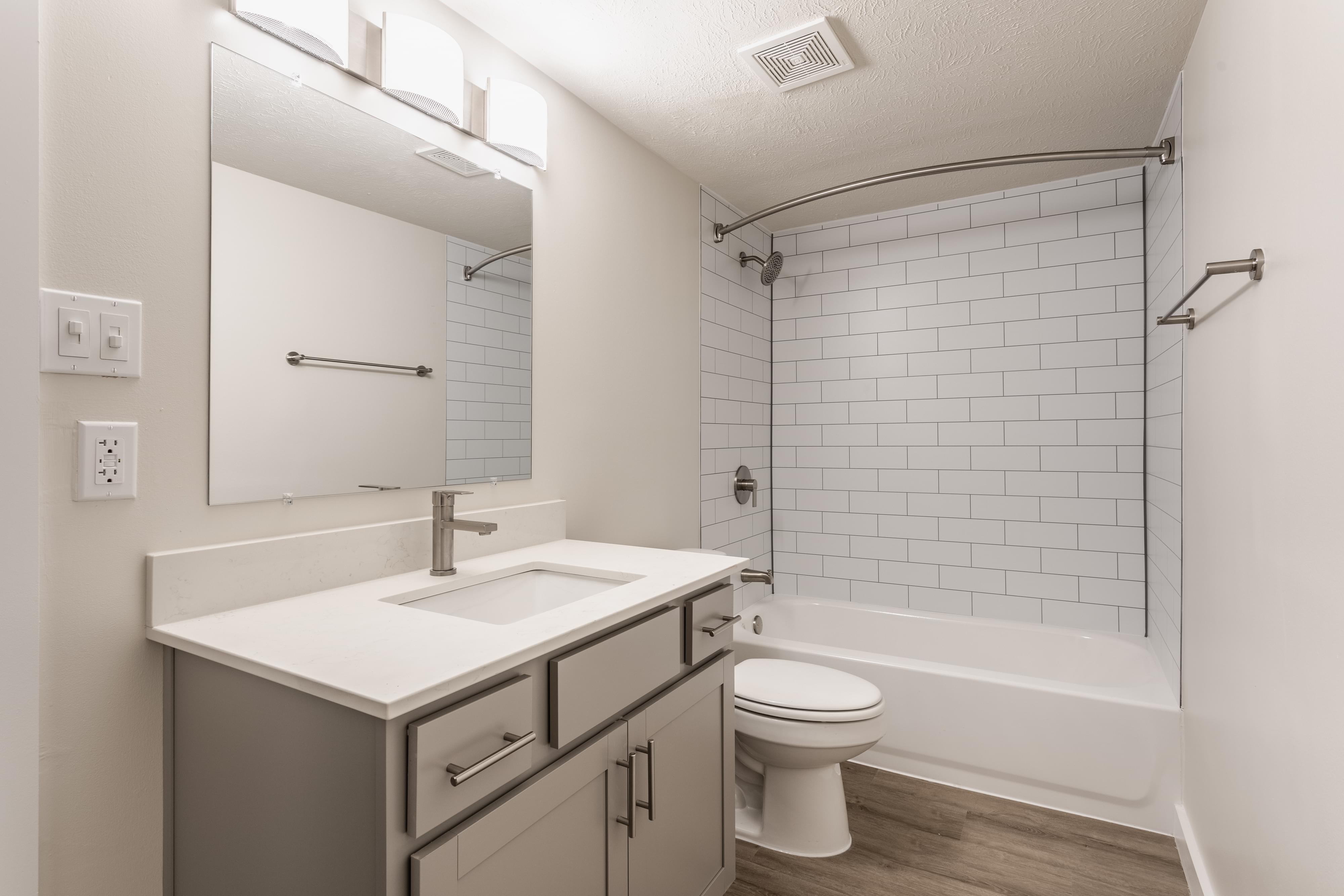 Grayscale version of kittens in a basket looking around.